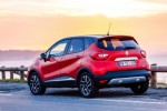 Red car parked on highway against sunset background