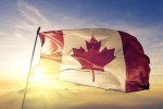 Porque você deve conhecer o Canadá na sua próxima viagem Canada Canadian flag textile cloth fabric waving on the top sunrise mist fog