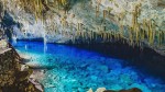 10 destinos nacionais para viajar em março com voos ida e volta até R$500 Inside the grotto of Lago Azul, a grotto with a lake with transparente vibrant blue water