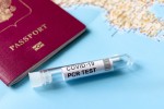 Seguro da GTA garante desconto em testes de Covid-19 COVID-19, travel and test concept, tube for PCR testing and tourist passport on geographic map