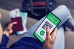 vaccinated person using digital health passport app in mobile phone for travel during covid-19 pandemic