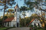 Rota Romântica é um pedacinho da Europa no Rio Grande do Sul Church with belfry and house in a wooden park