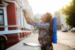 5 dicas essenciais para quem vai viajar ao exterior pela primeira vez young-beautiful-african-female-traveler-with-backpack-smiling-making-selfie