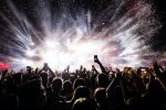 Confetti fireworks above the crowd on music festival.