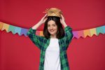 Festas Juninas entram na rota das férias de inverno festa-junina-cute-young-girl-green-shirt-celebrating-brazilian-festival-taking-straw-hat-off